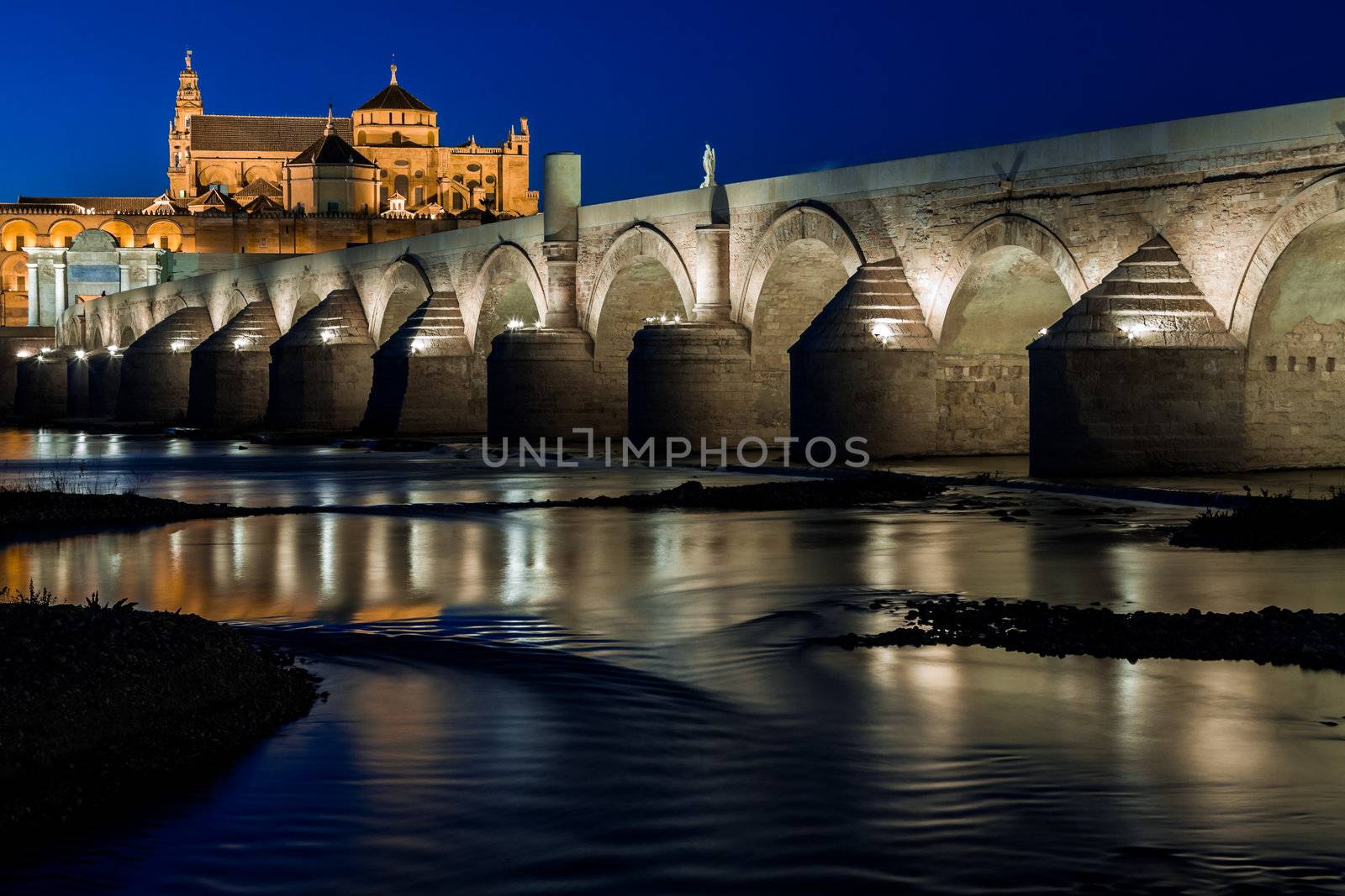 Cityscape of Cordoba at sunset with roman bridge and Mezquita, Andalusia, Spain