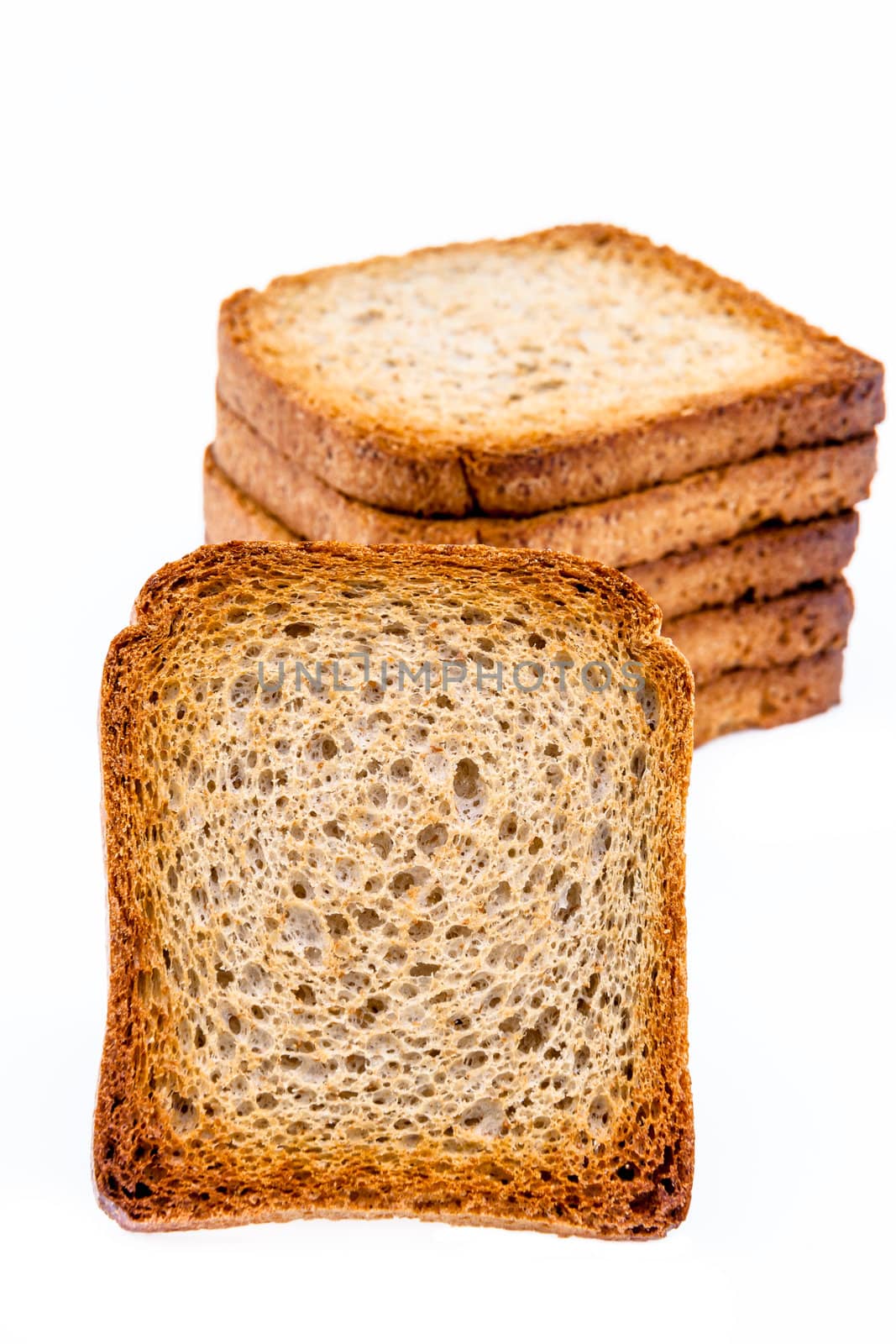 A slice of toast and a pile of slice of toast