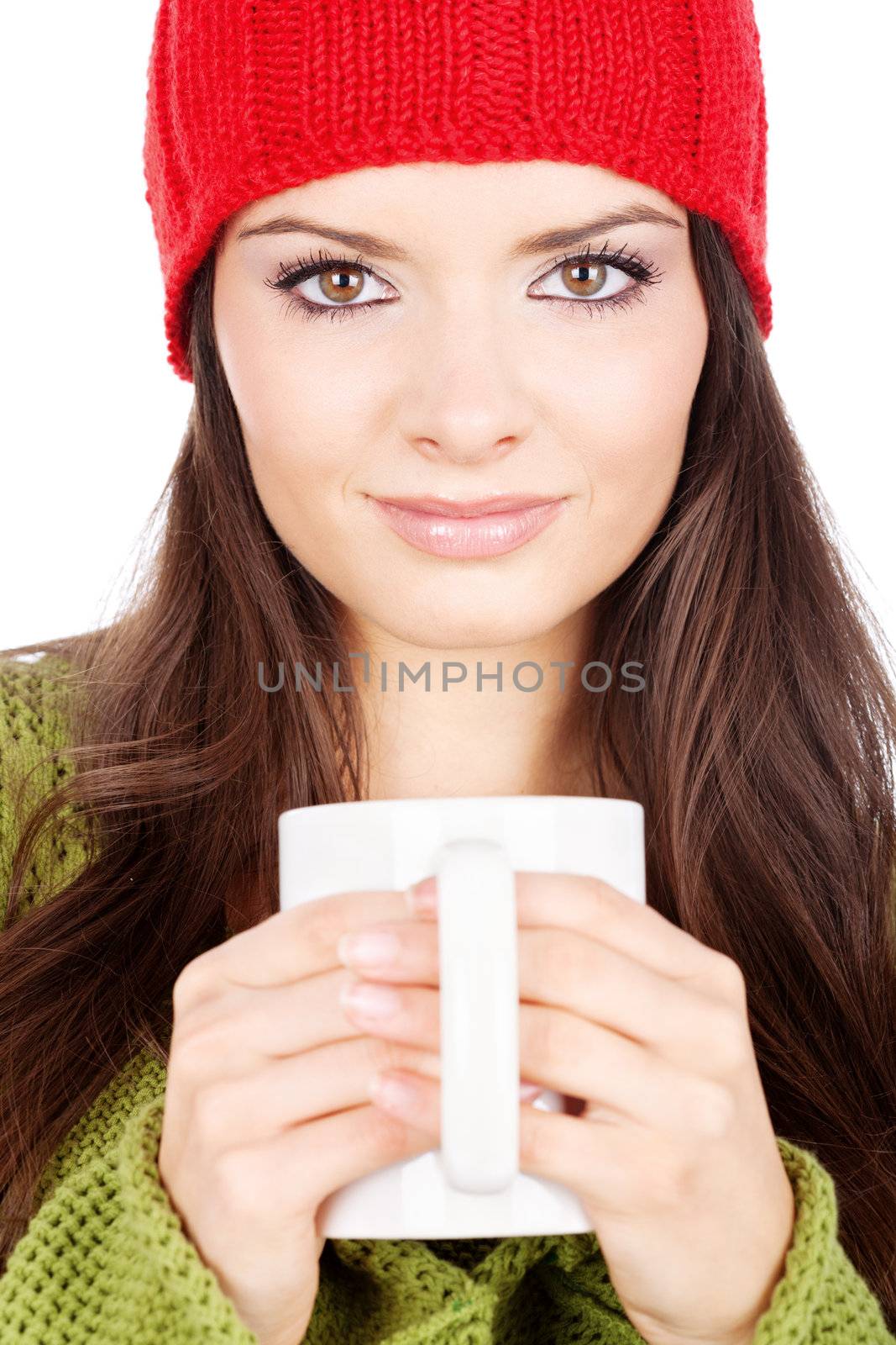 young brunette woman in wool sweater and cap holding a teapot, isolated on white