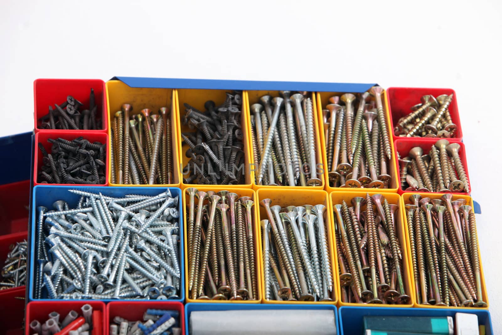 Toolbox with segregated new metal long bolts, screws in different sizes and types