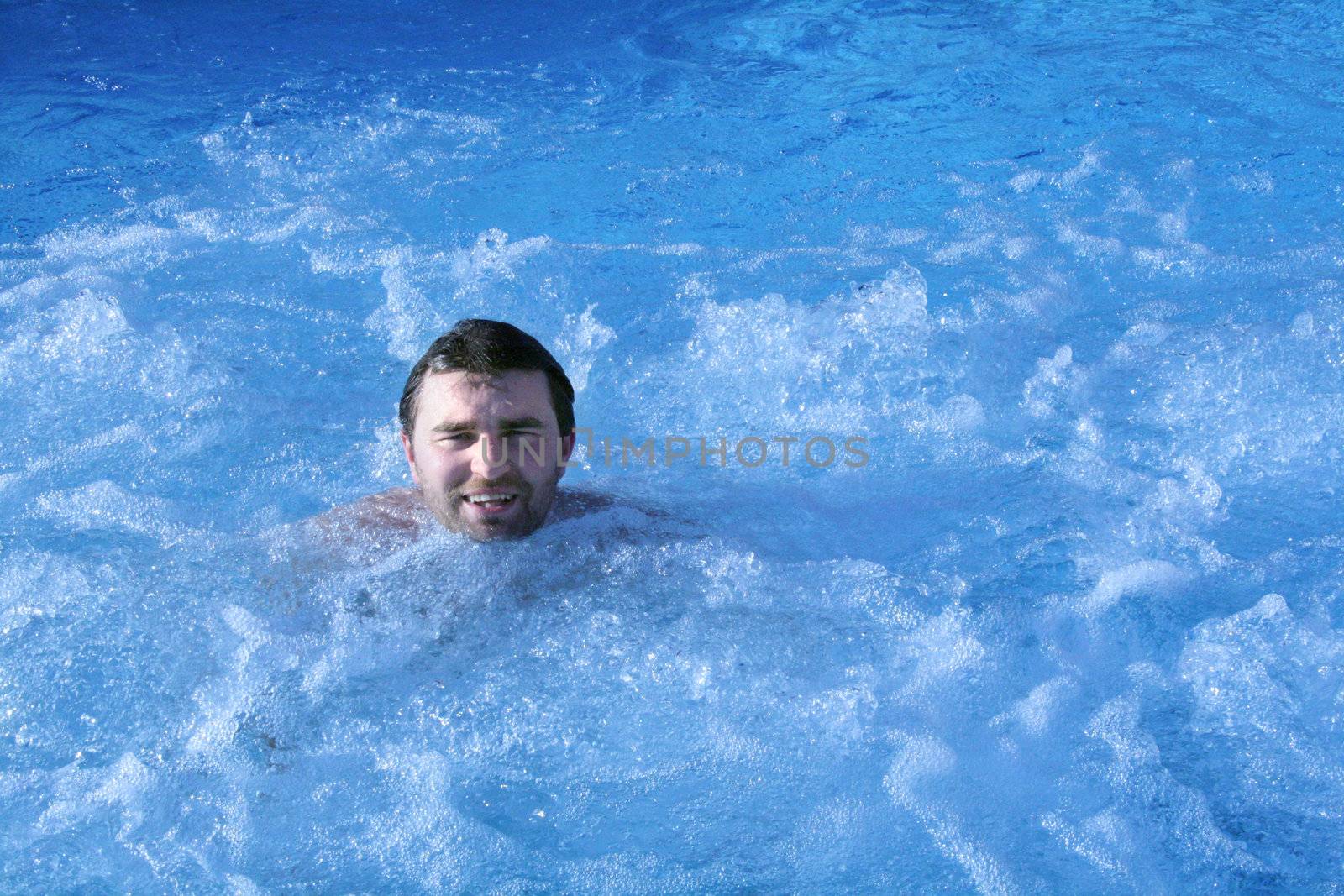man in jacuzzi of spa center  by photochecker
