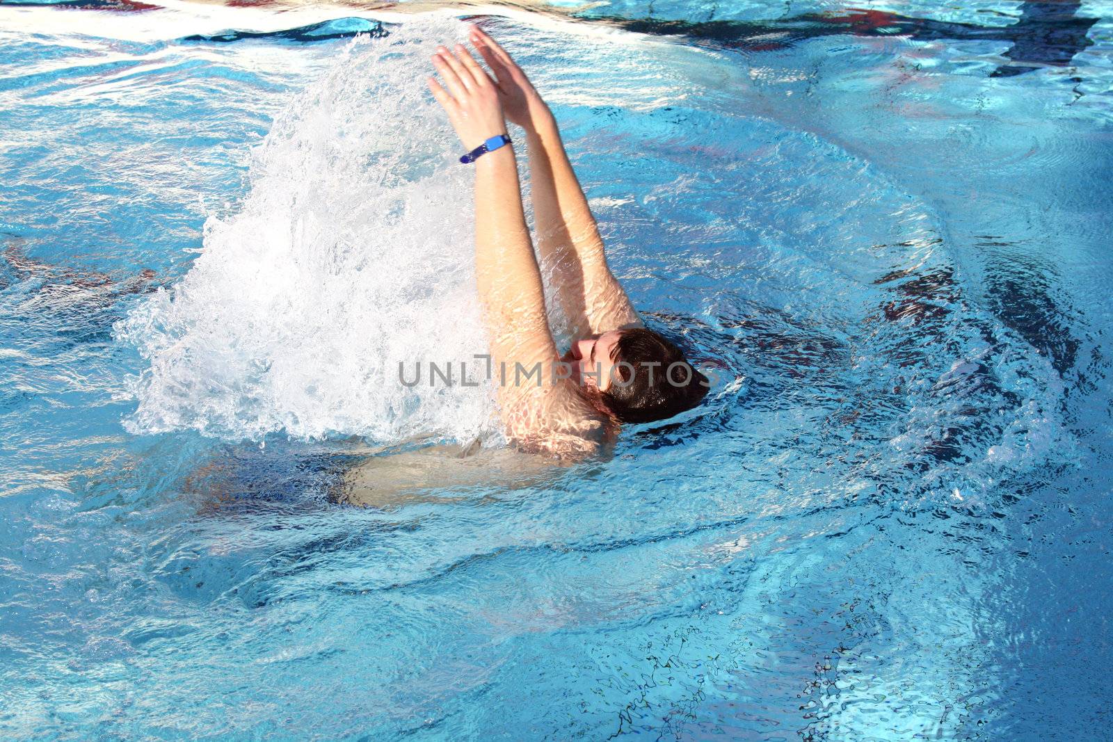 young man learn swimming backstroke in pool by photochecker
