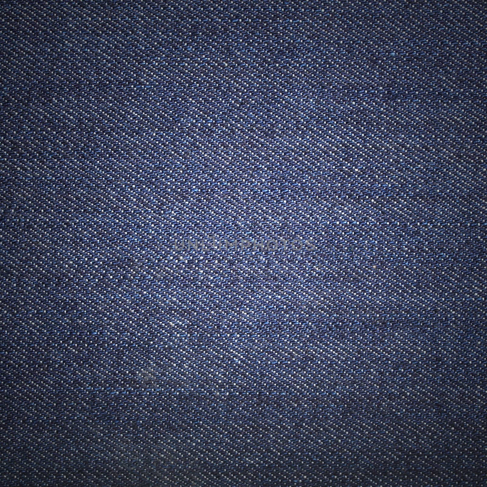Texture of blue jeans textile close up
