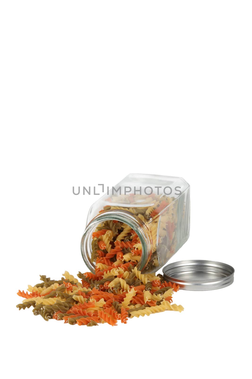 Dried pasta spilling from jar by phovoir