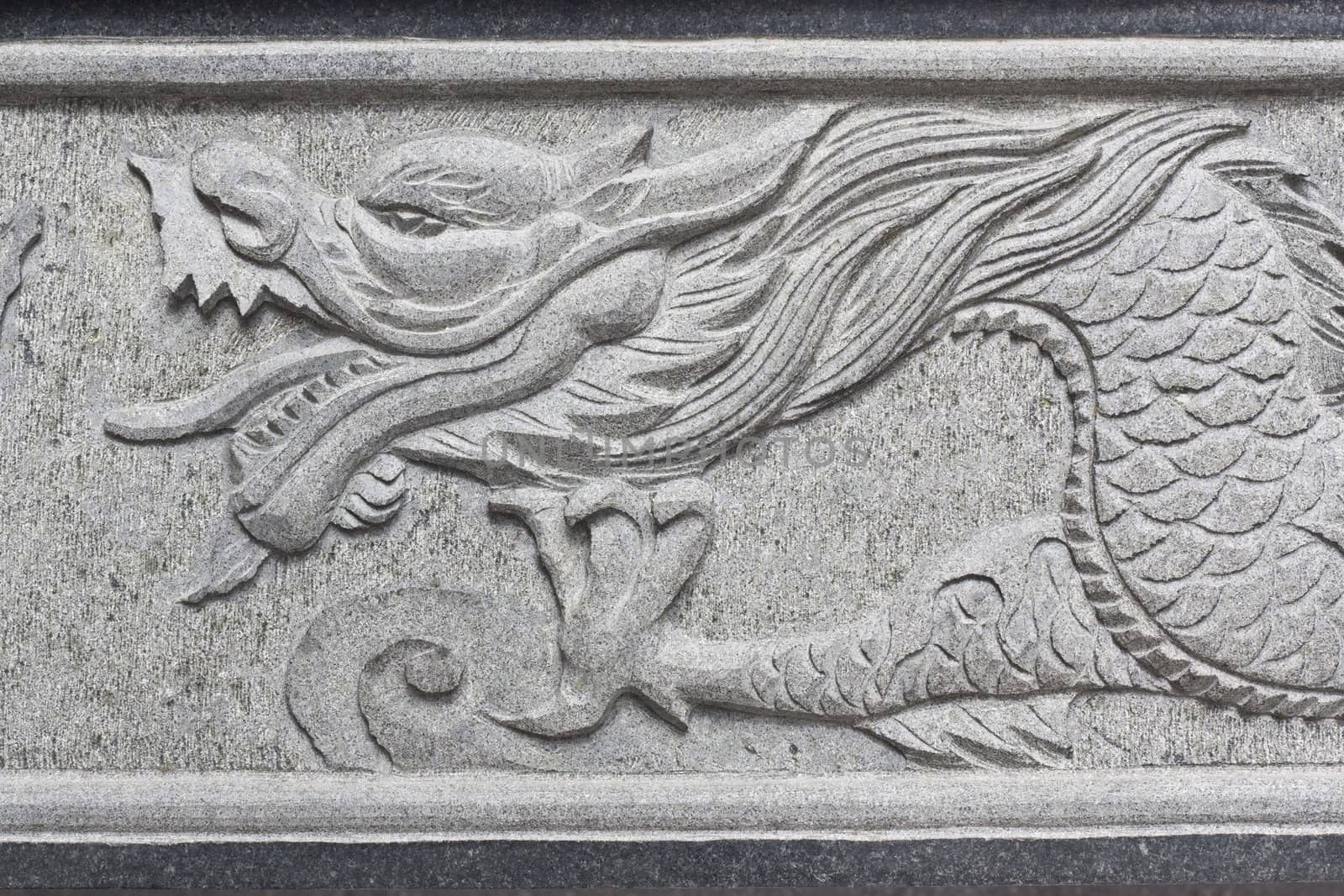 stone carving, the carving is a beautiful dragon.