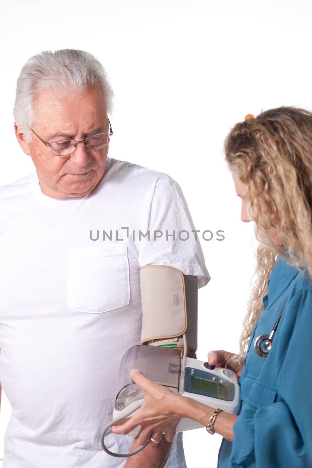 nurse takes blood pressure from senior patient