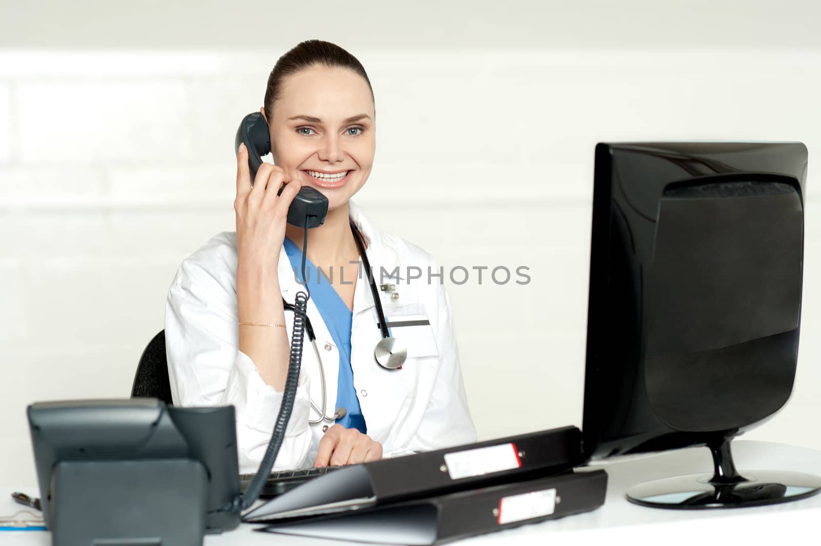 Beautiful nurse talking on phone with patient sitting in her chamber