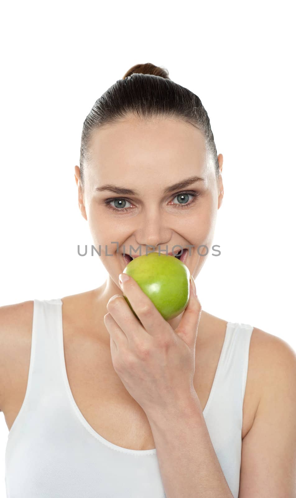 Closeup portrait of beautiful woman eating fresh green apple isolated against white background