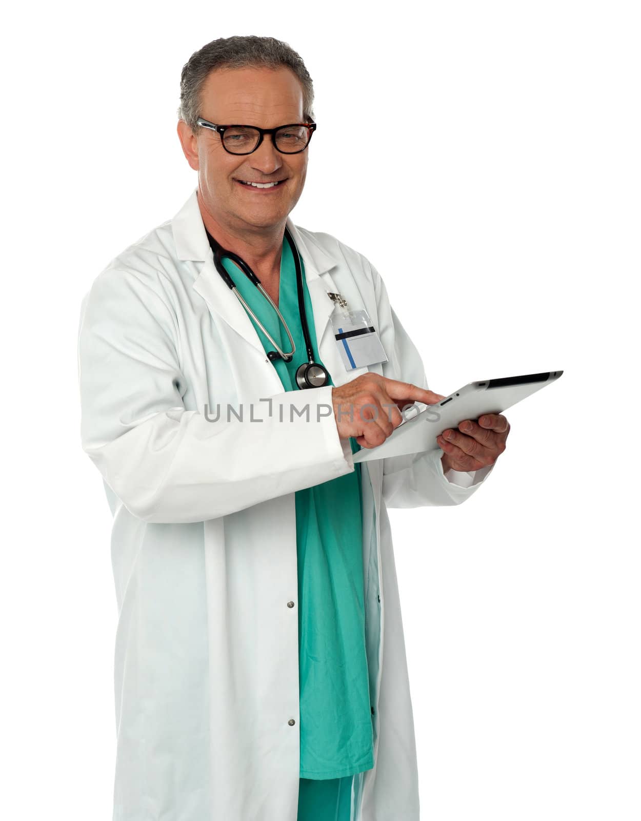 Cheerful doctor using wireless tablet device looking at you