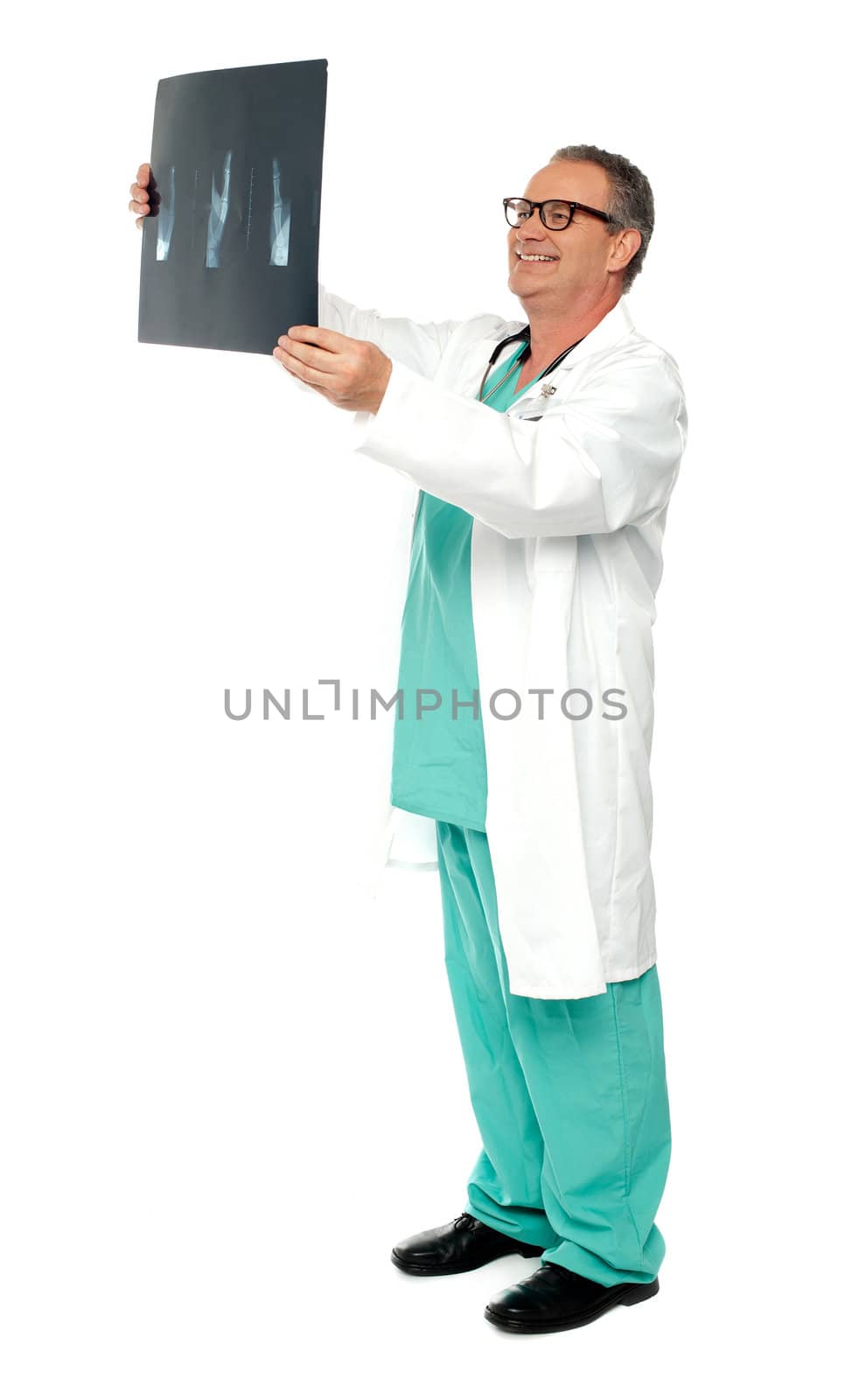 Full length portrait of senior surgeon holding x-ray report a patient