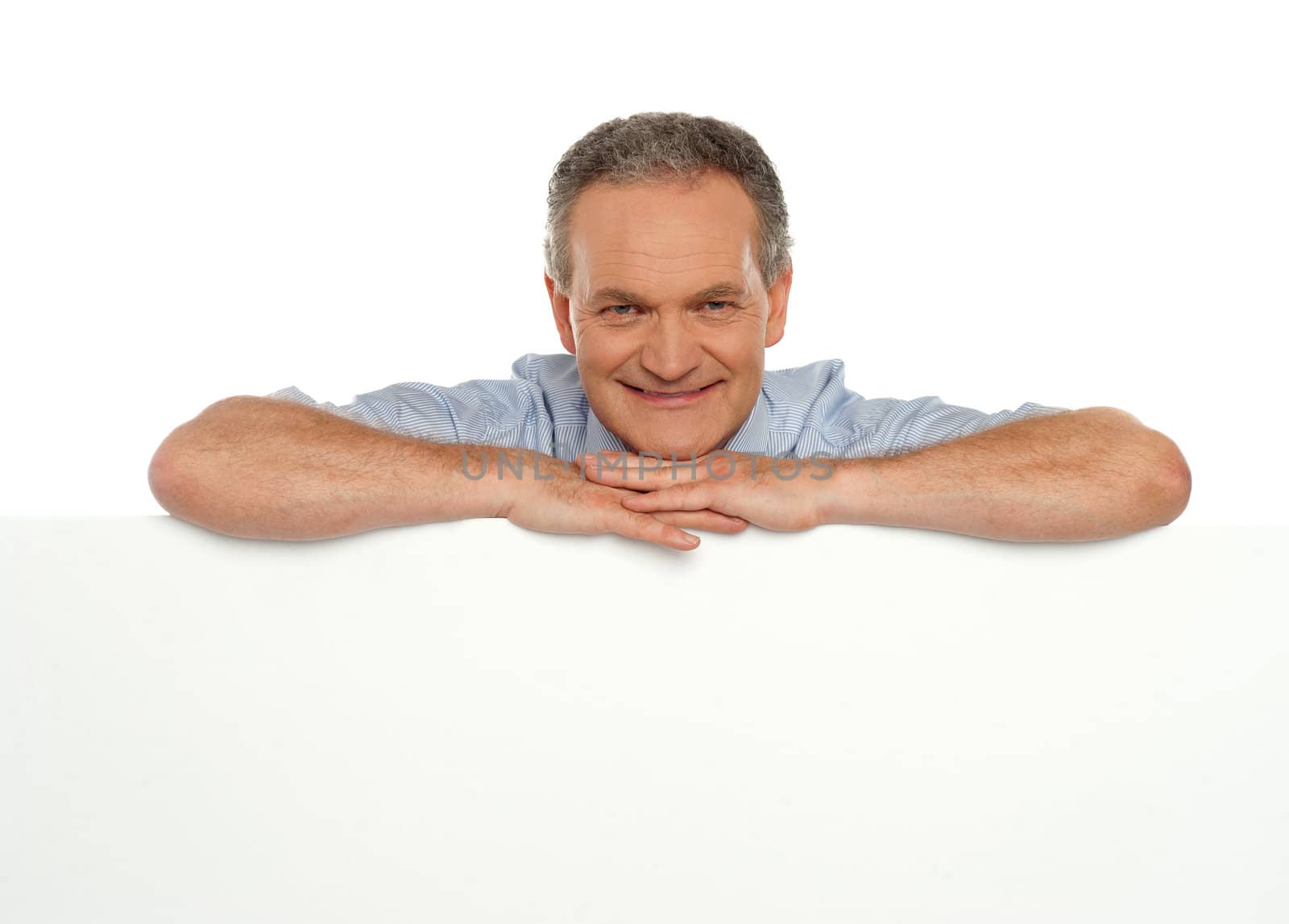 Smiling man behind blank white banner ad looking at you