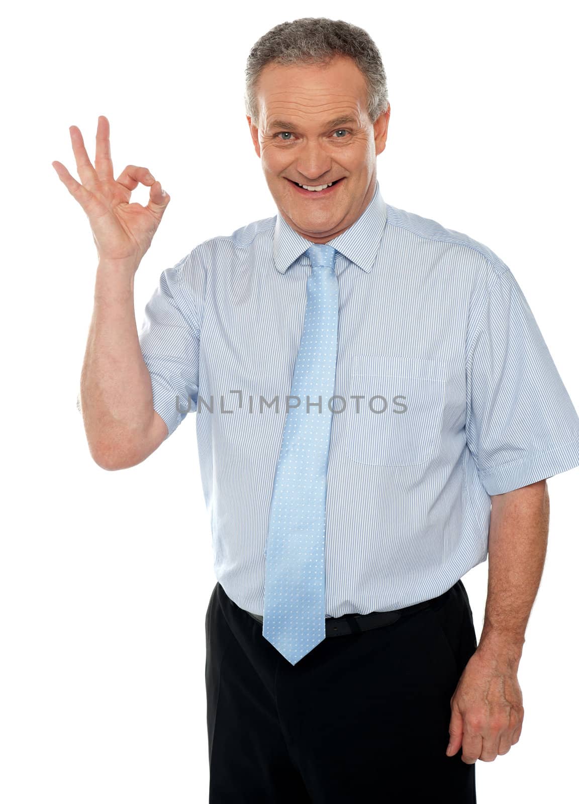 Cheerful male executive showing okay sign to camera. Isolated on white background