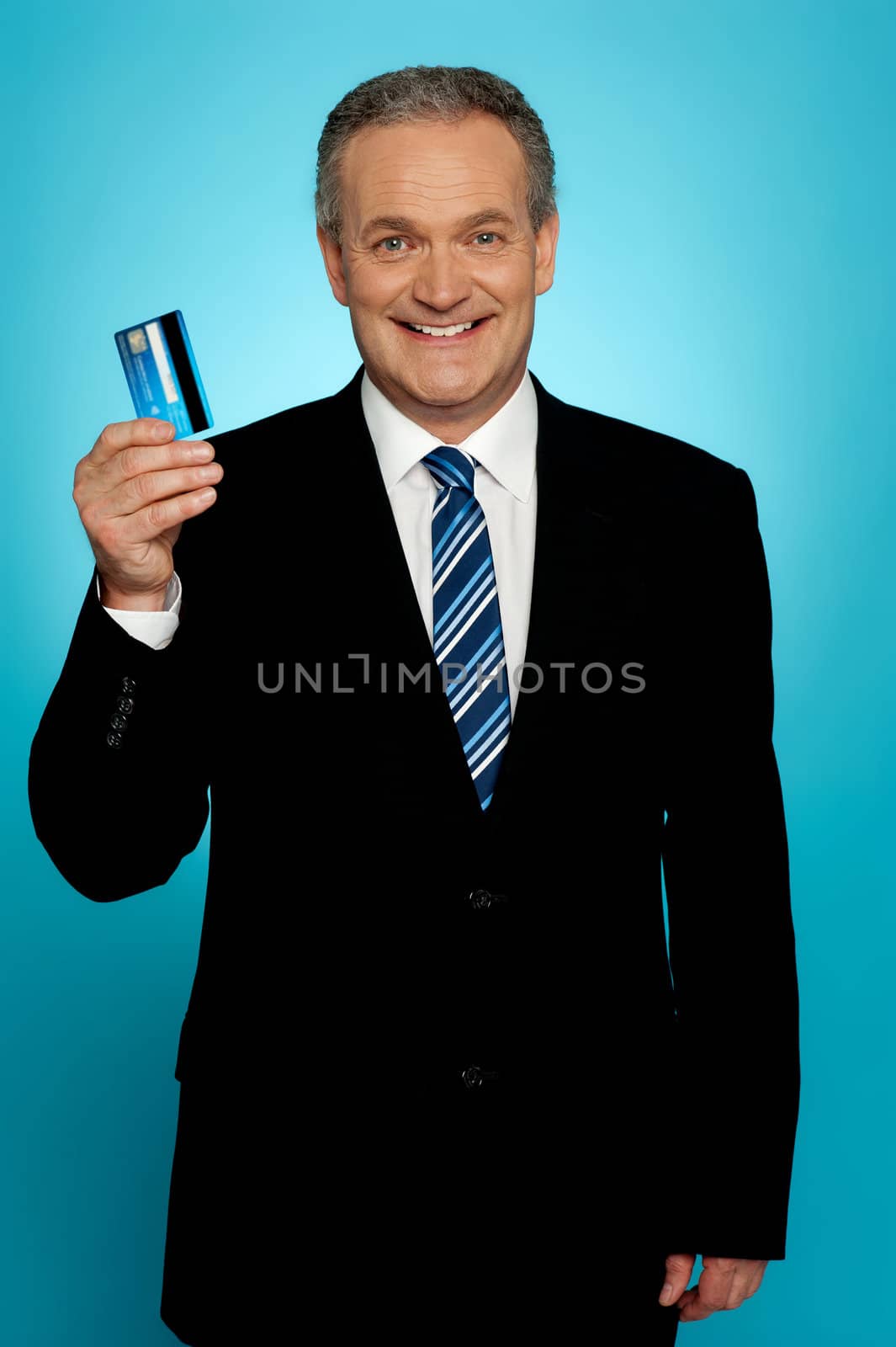 Senior executive showing credit card to camera