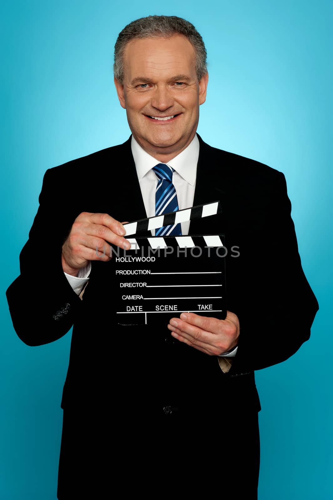 Its showtime. Businessman holding clapperboard