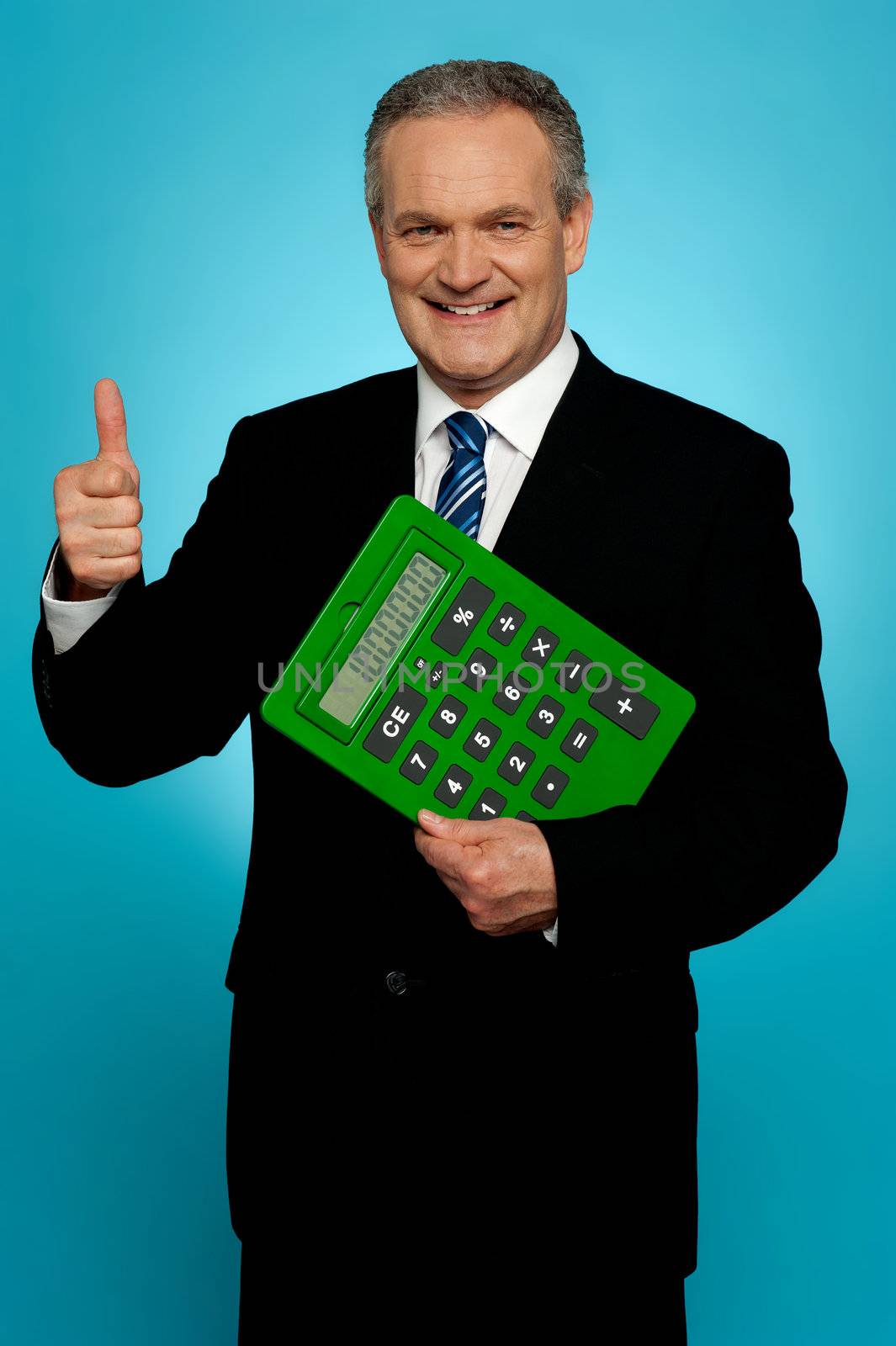 Businessman showing thumbs up, holding calculator. All on gradient blue background
