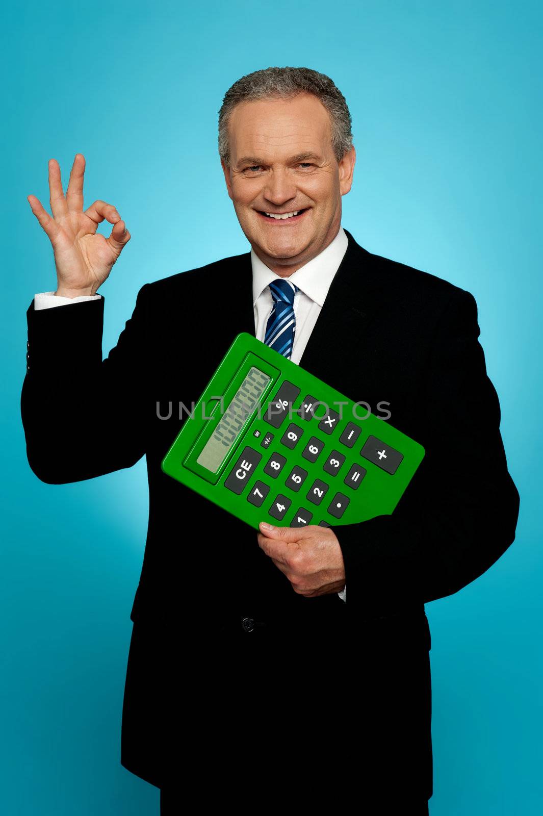 Confident executive holding calculator and gesturing okay sign isolated over gradient background