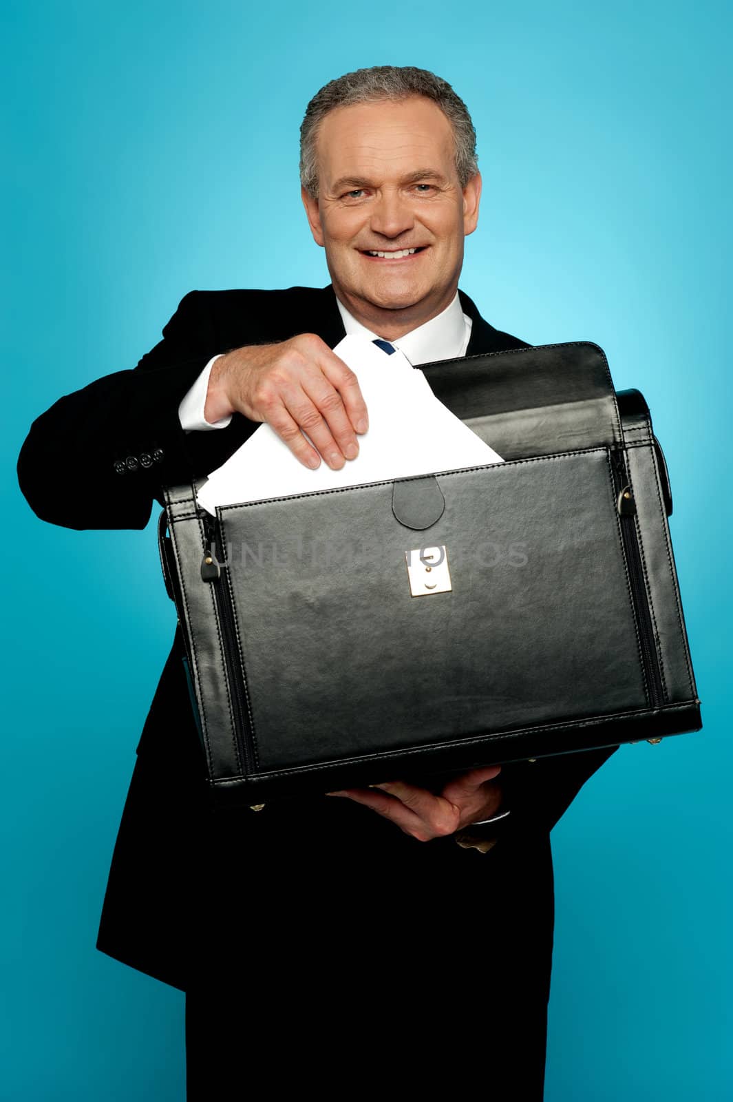 Isolated businessman keeping documents safely in a briefcase