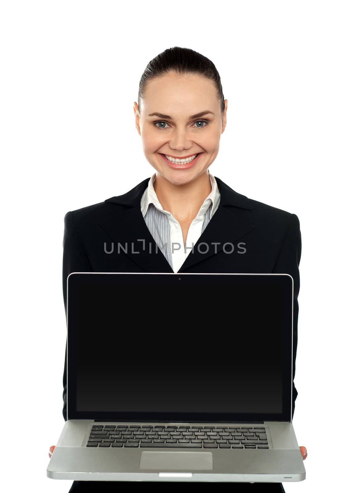 Cheerful female executive presenting brand new laptop to you