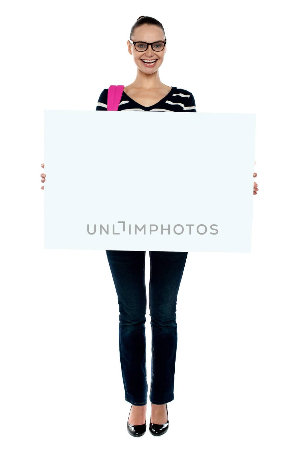 Full length shot of college girl holding white ad board and smiling at camera
