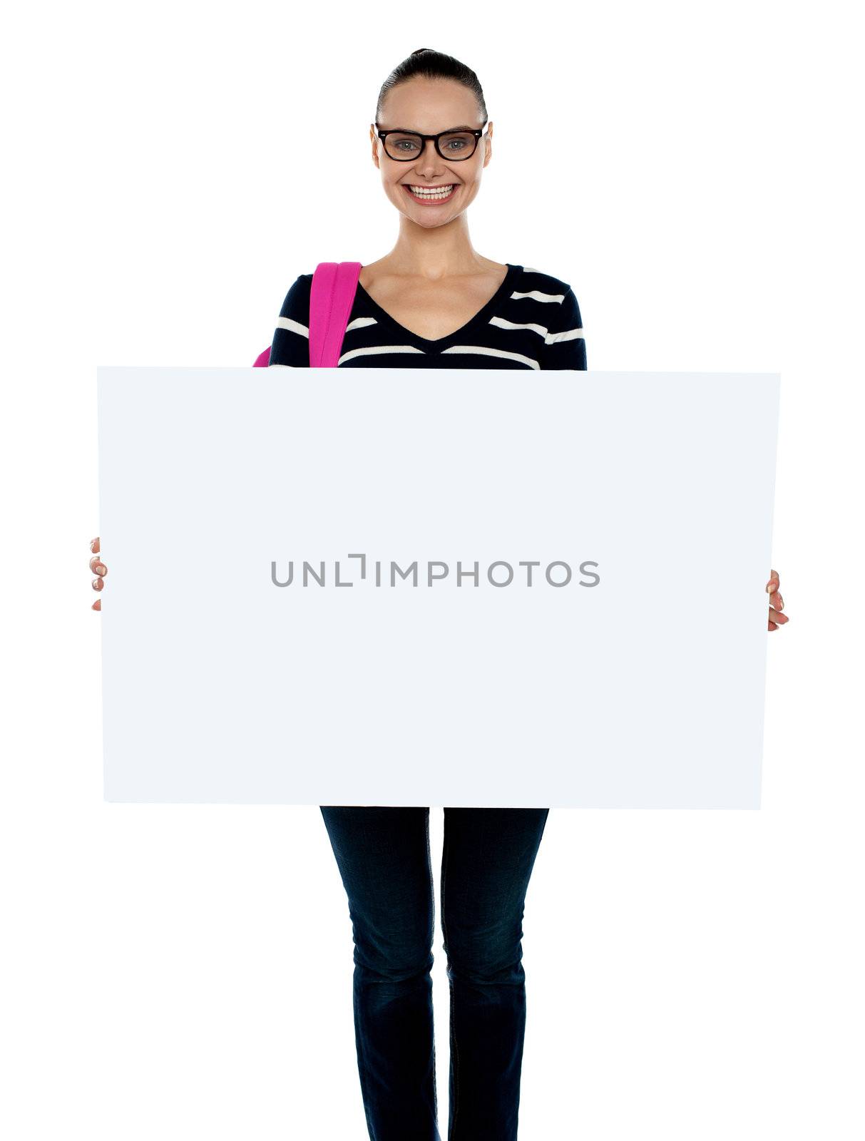 Smiling isolated teenager presenting white blank billboard