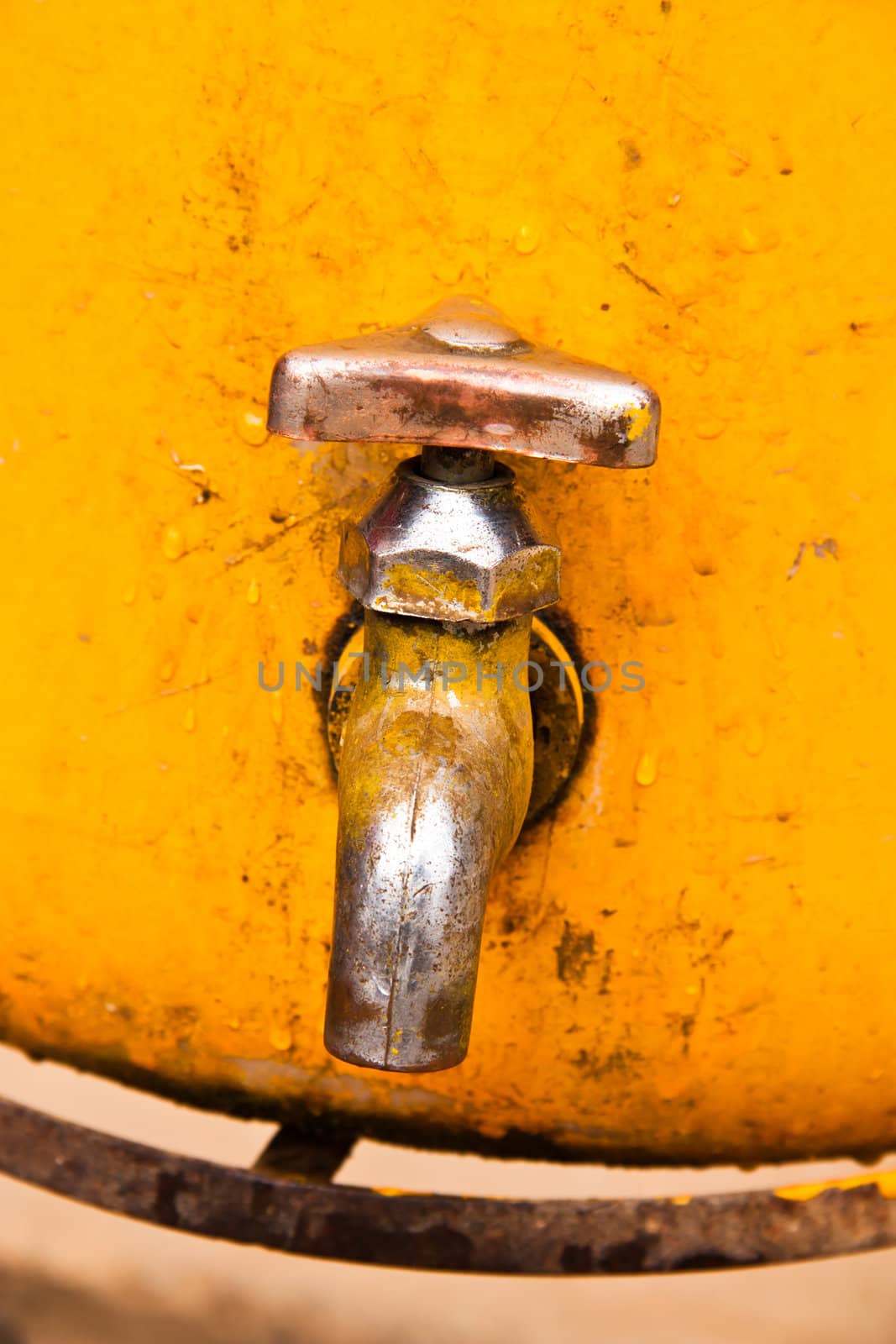 Faucet is mounted on a yellow bucket.