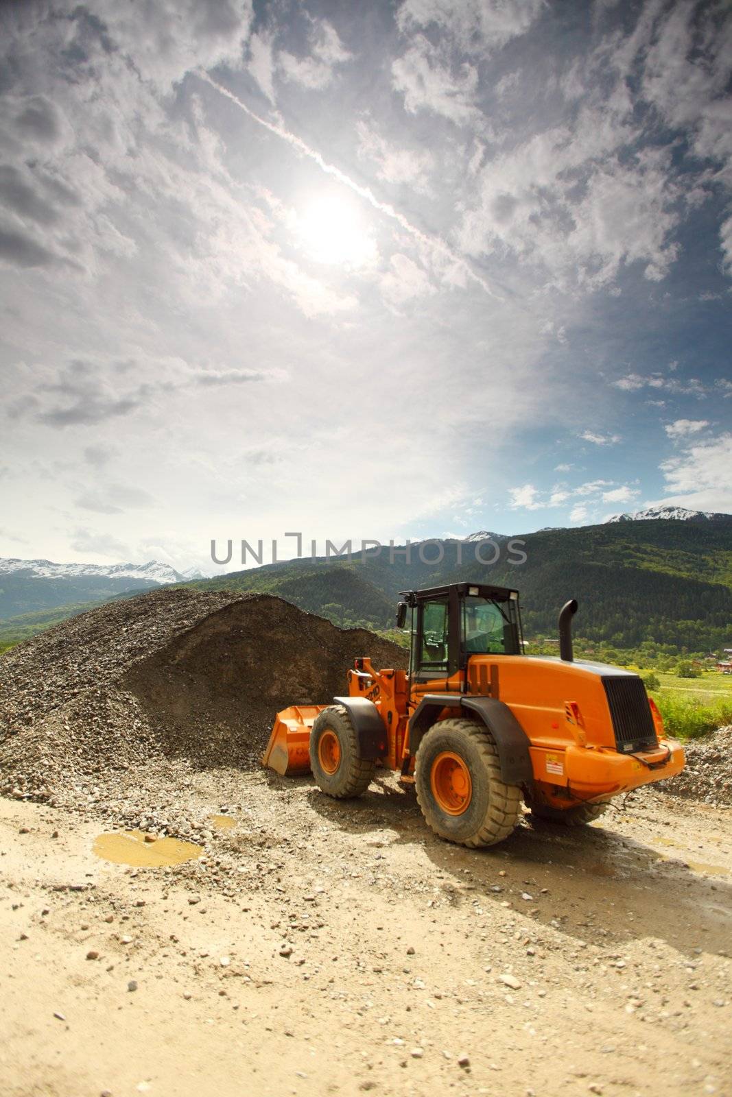 excavator in summer alps