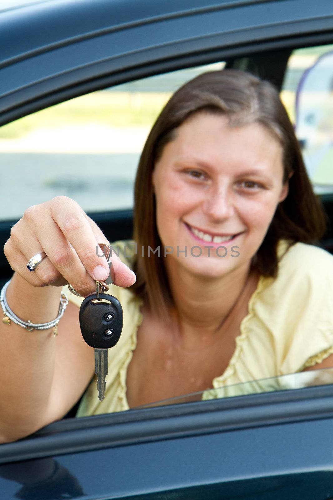 car driver woman smiling showing new car keys 