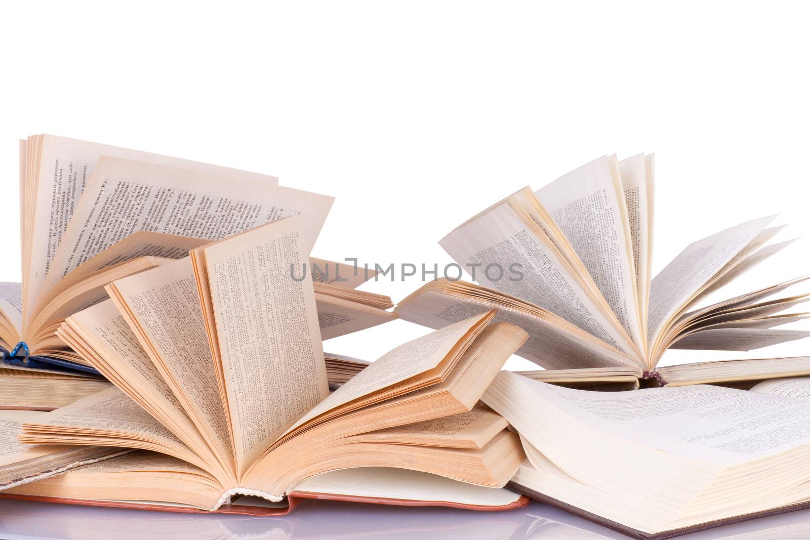 many opened books lying on the table