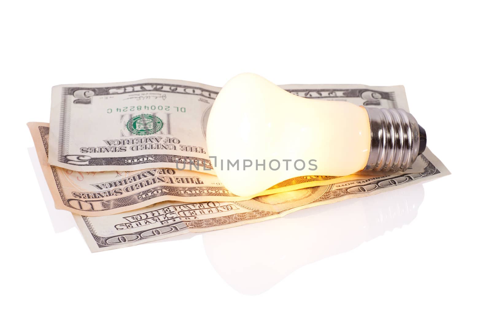 Old style bulb on dollars isolated on white