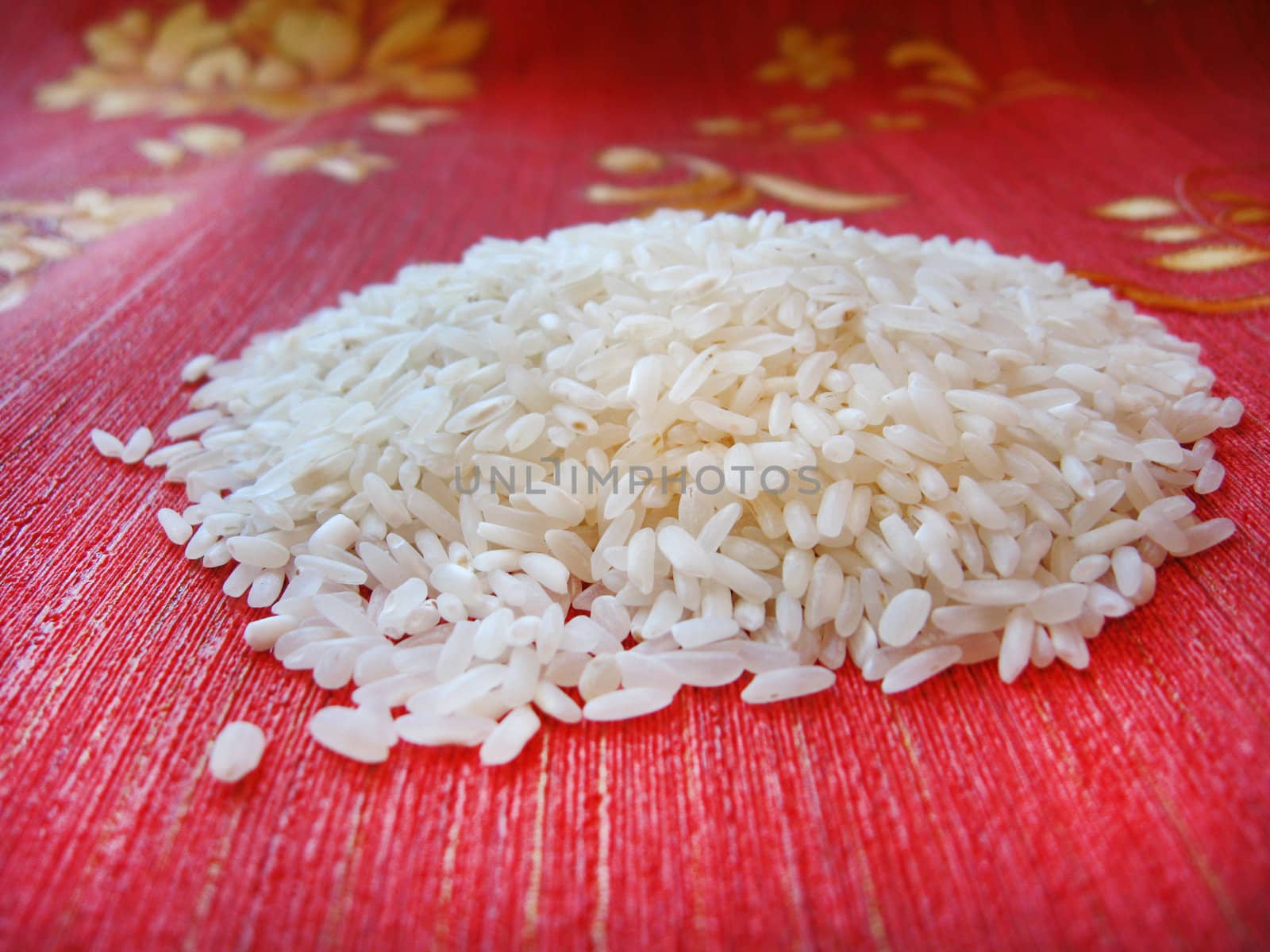 scattered rice on a red background by alexmak