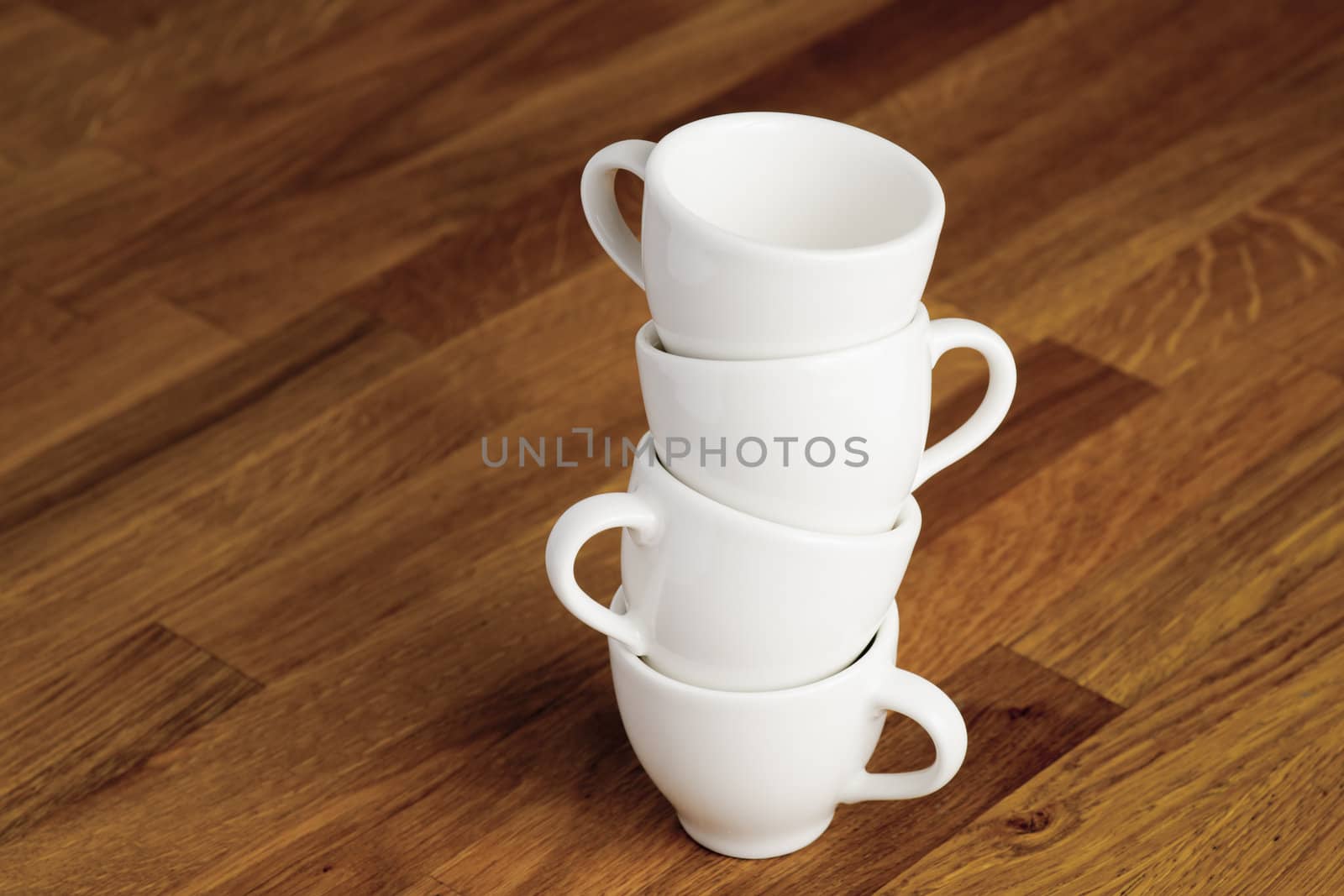 Stack of white china coffee cups.