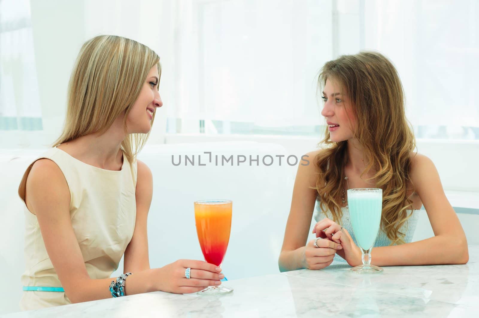 beautiful woman in a cafe talking and drinking beverages by adam121