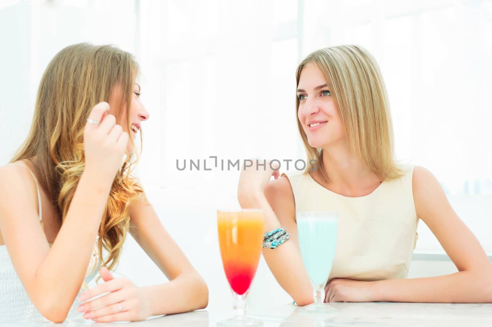 beautiful woman in a cafe talking and drinking beverages