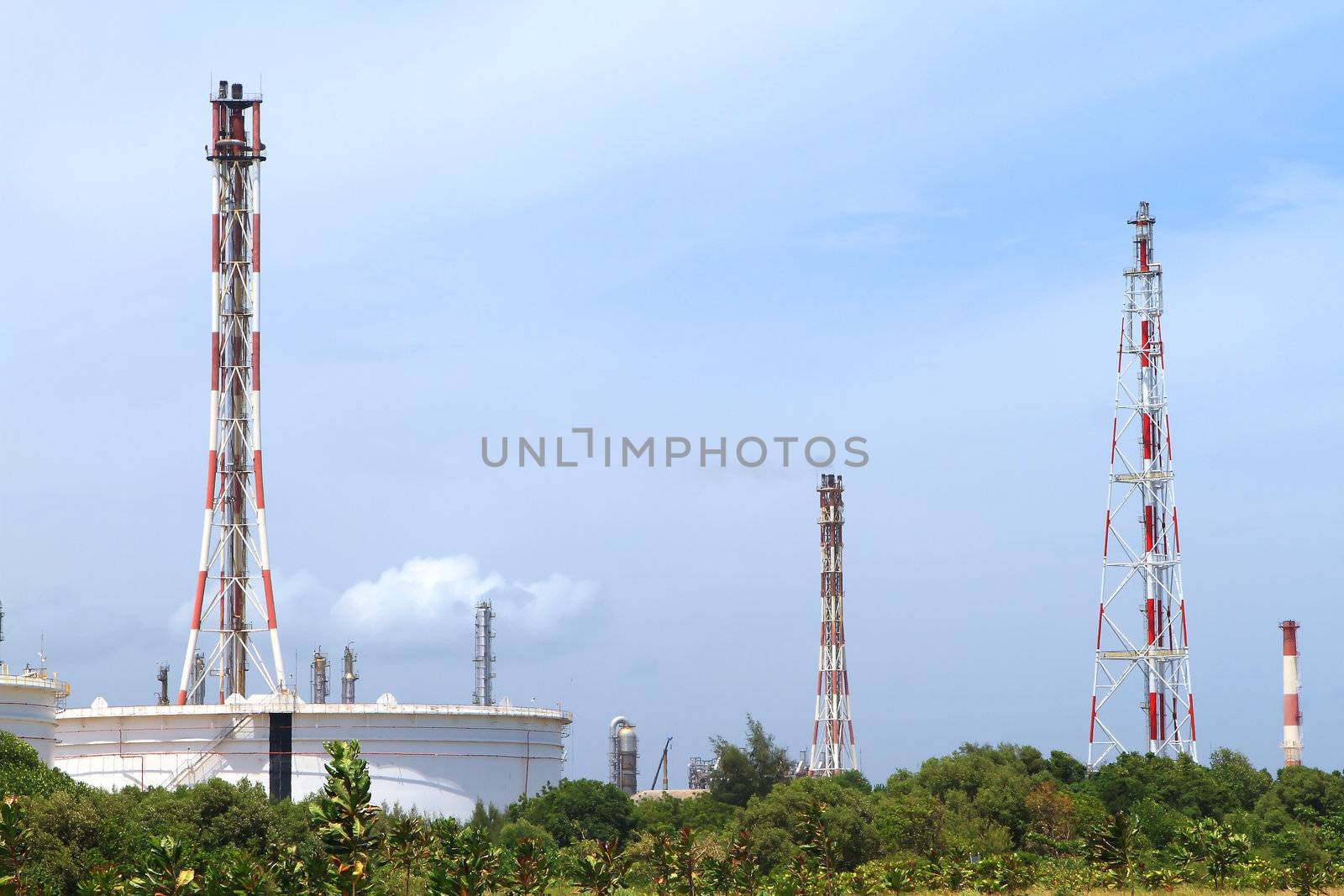 Flare burning gas at refinery plant by rufous