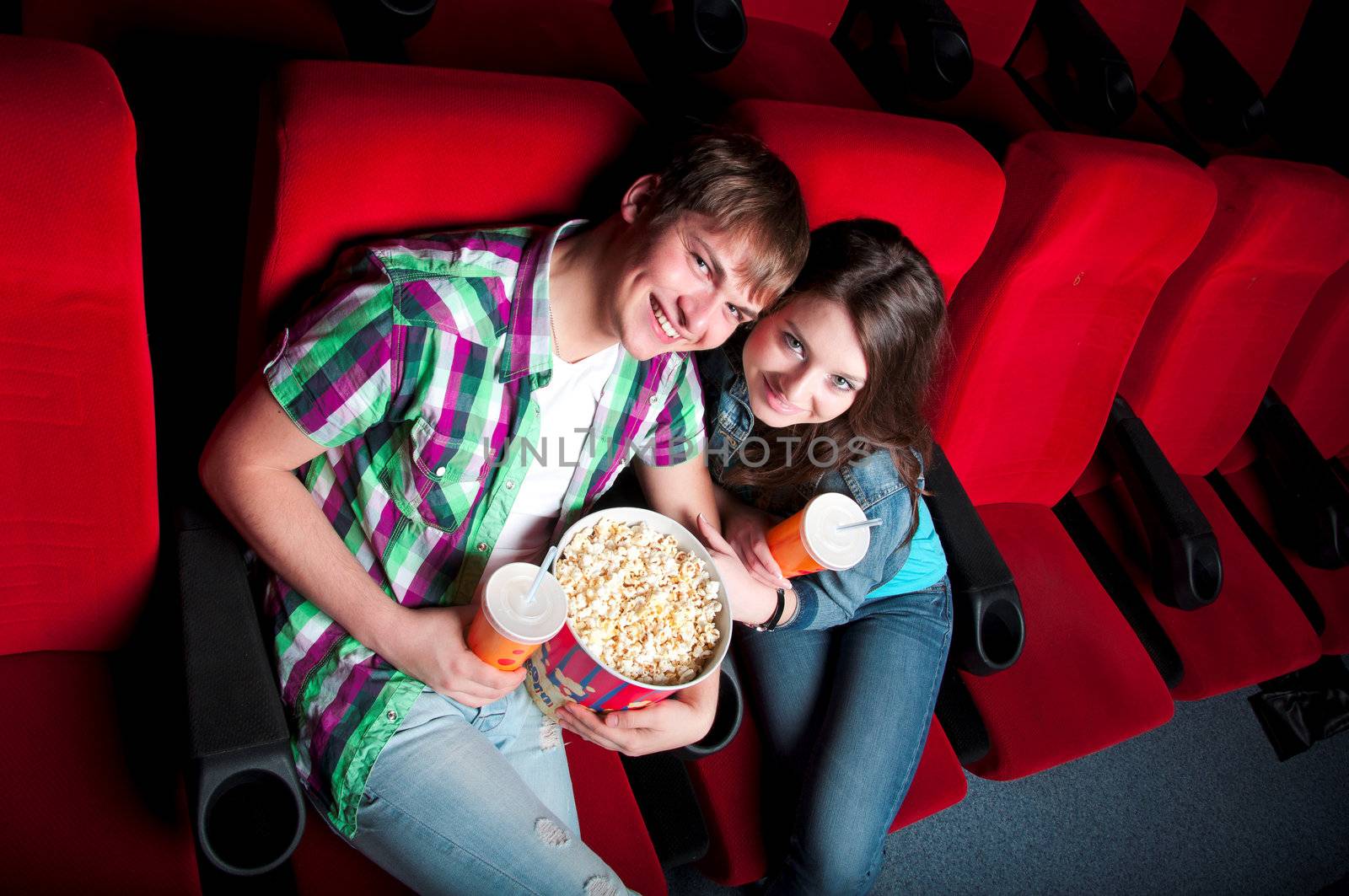 man and woman sitting in a movie theater