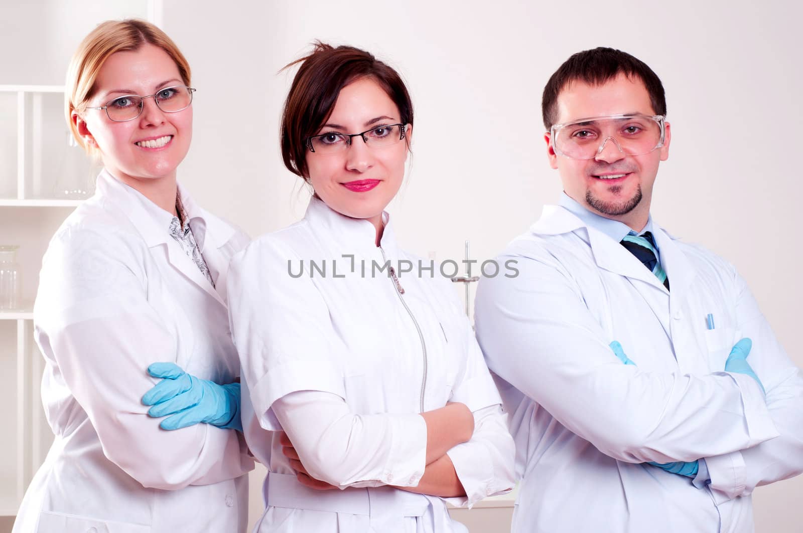 three doctors standing in a row with his arms crossed on his chest