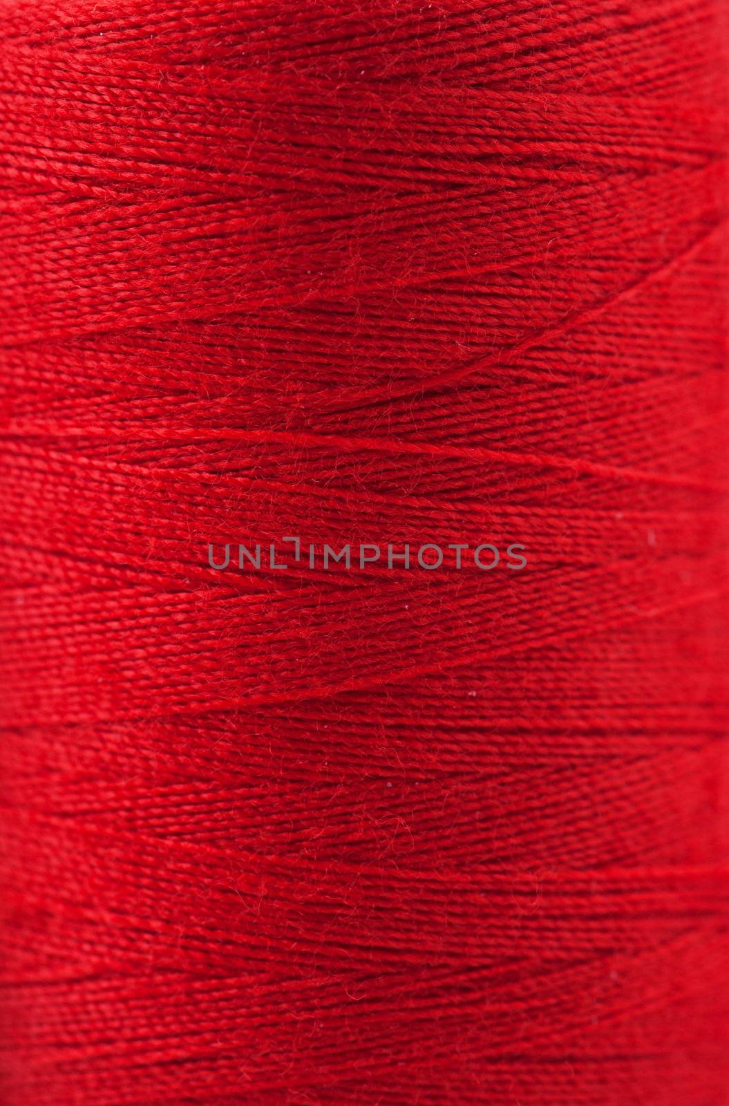 Macro view of red thread wound on a spool