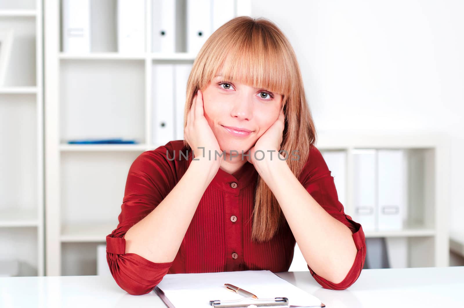 portrait of a beautiful woman in the office, sitting at the table