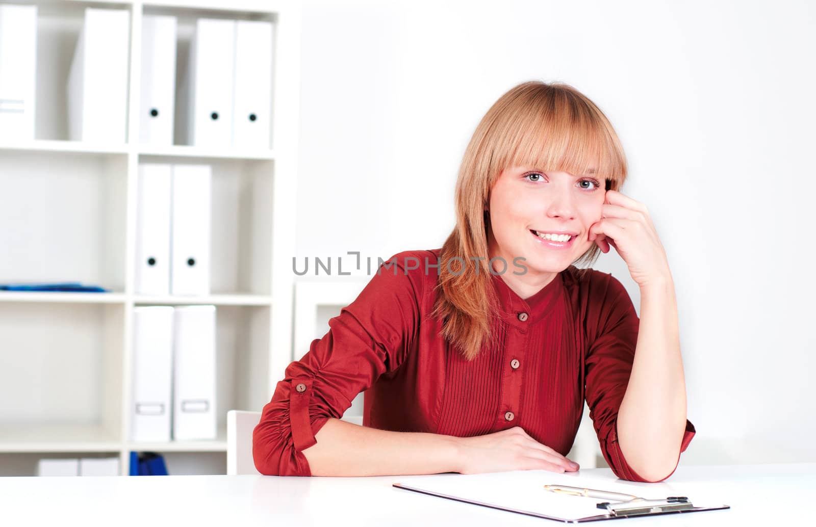 portrait of a beautiful woman in the office, sitting at the table