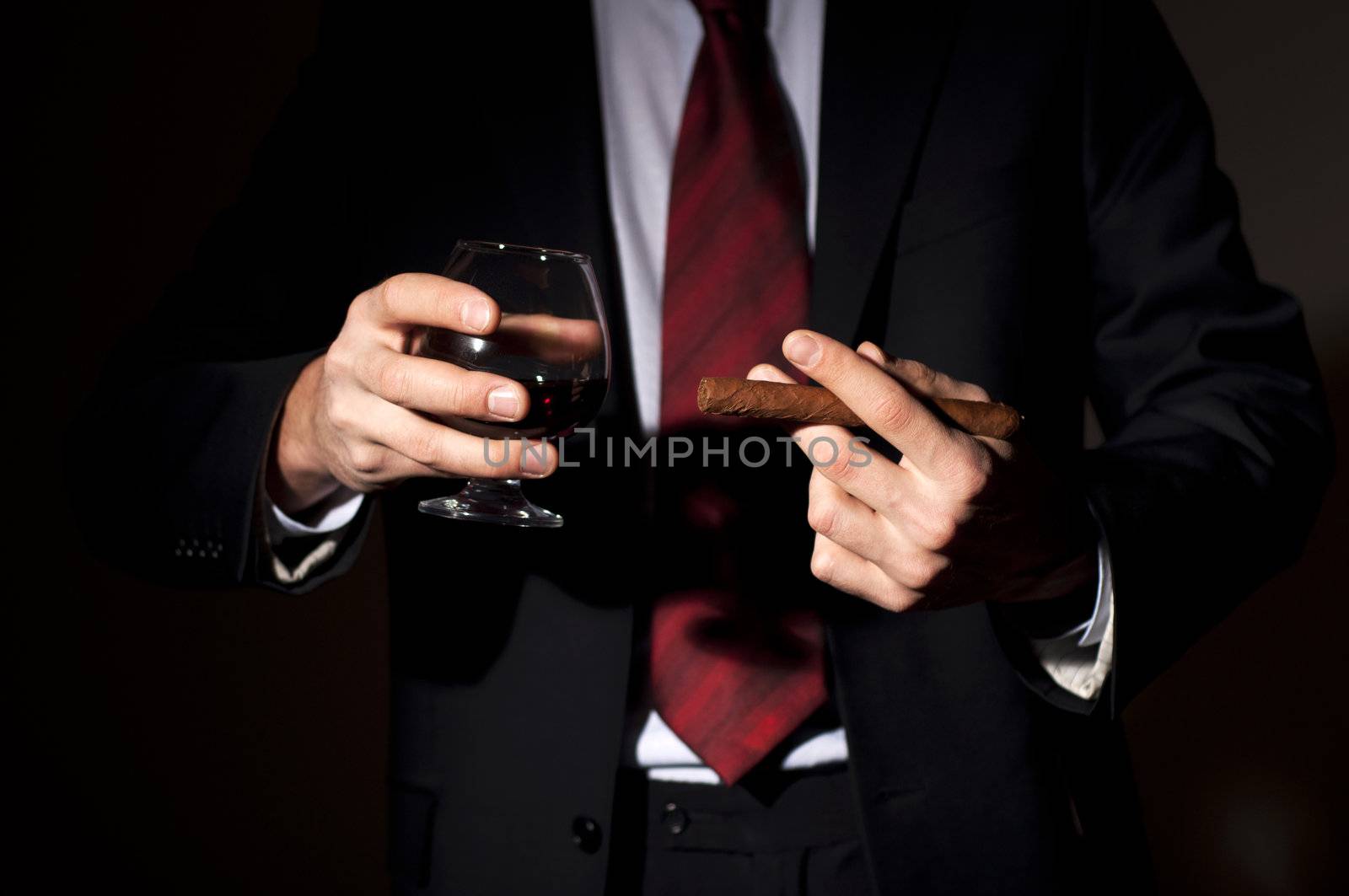 rich person, holds a cigar and whisky