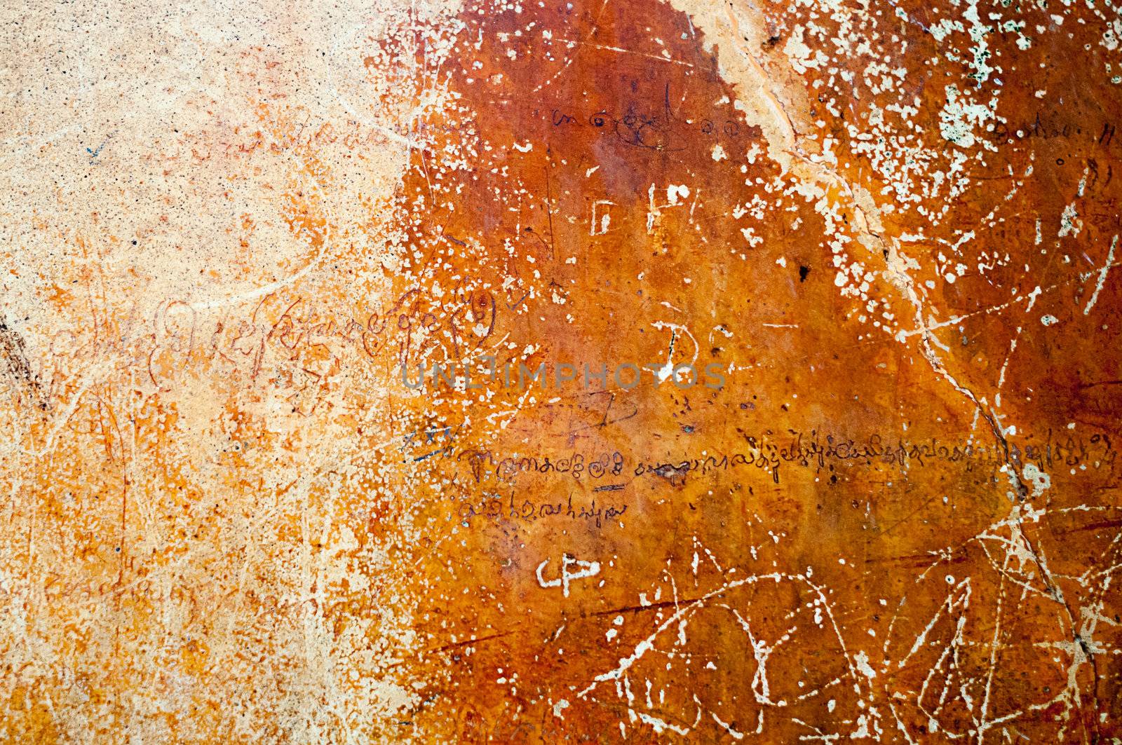 Ancient wall on Sigiriya rock in Sri Lanka with romantic verses in ancient language