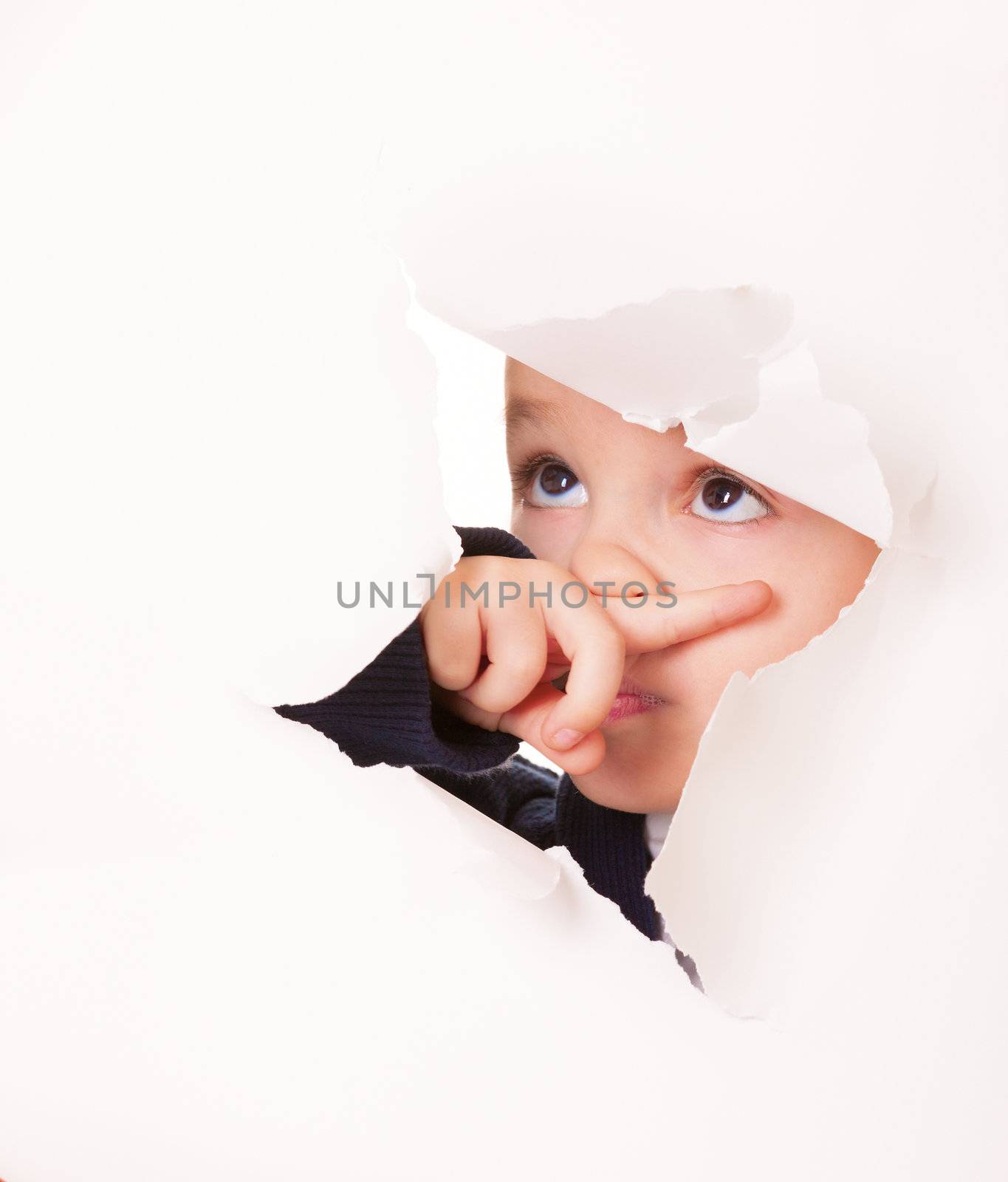 Guilty kid looks up through a hole in white paper