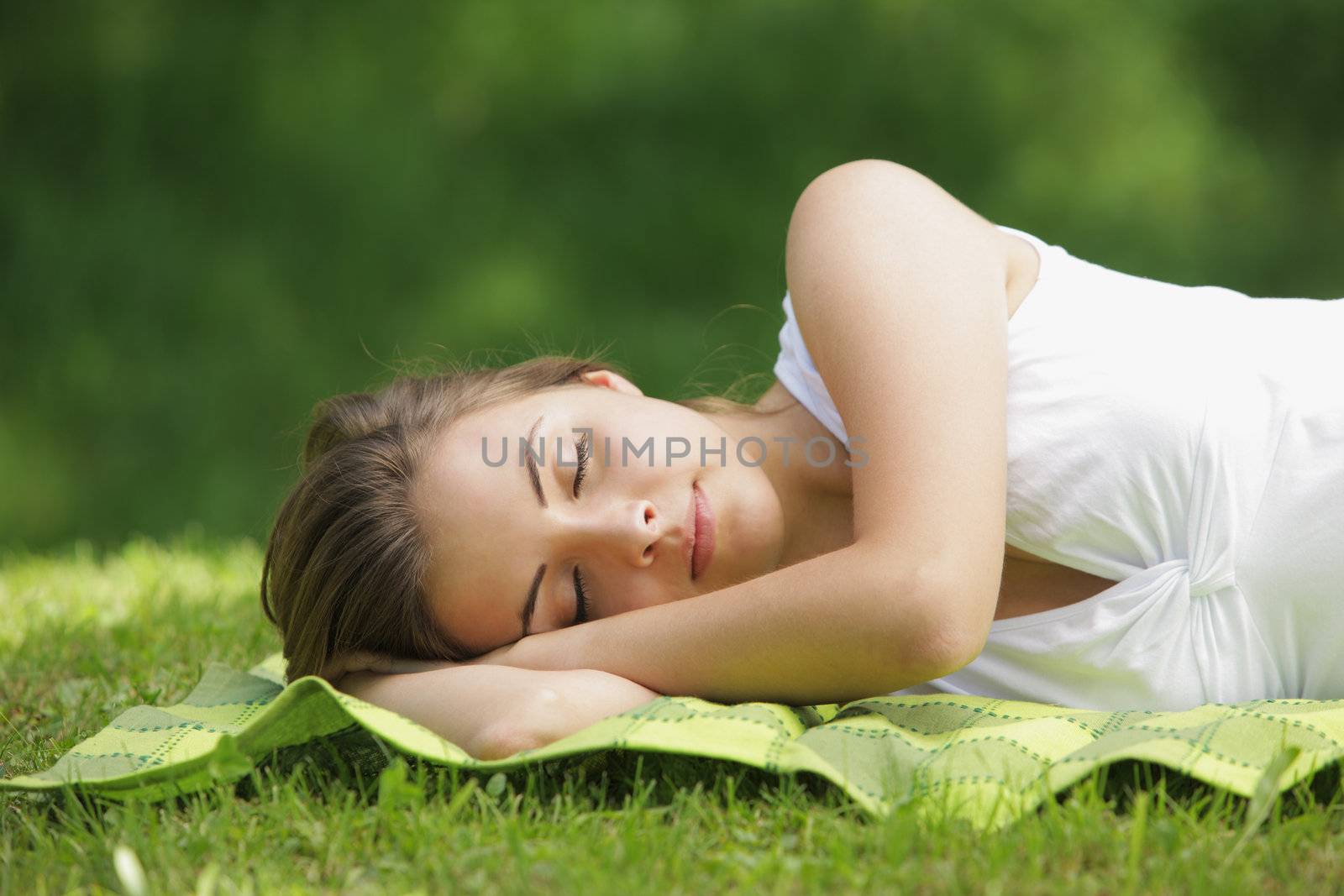 Beautiful woman lying and sleep on the grass