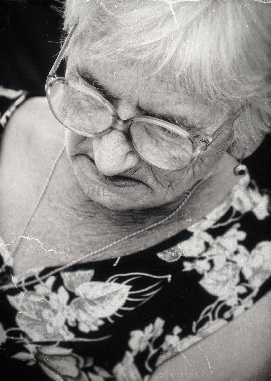 Old image of an unhappy senior woman-NOTE:Texture was added to simulate an old image.