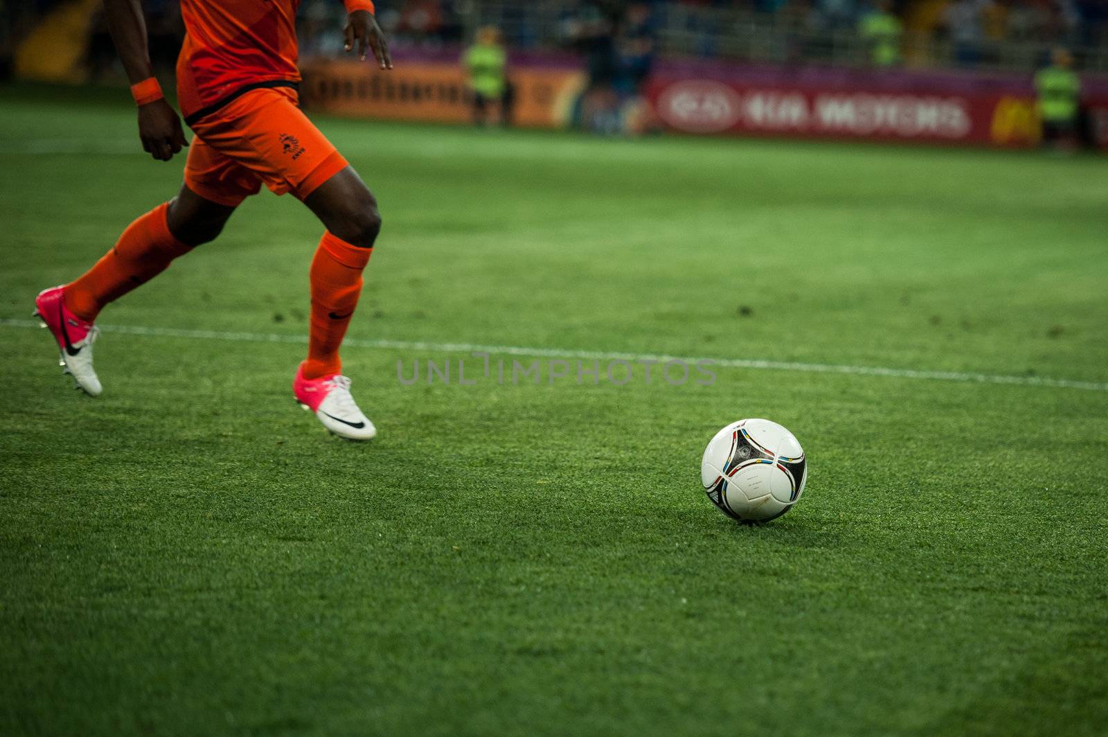 A soccer ball being kicked by the foot of a soccer player on the by shivanetua