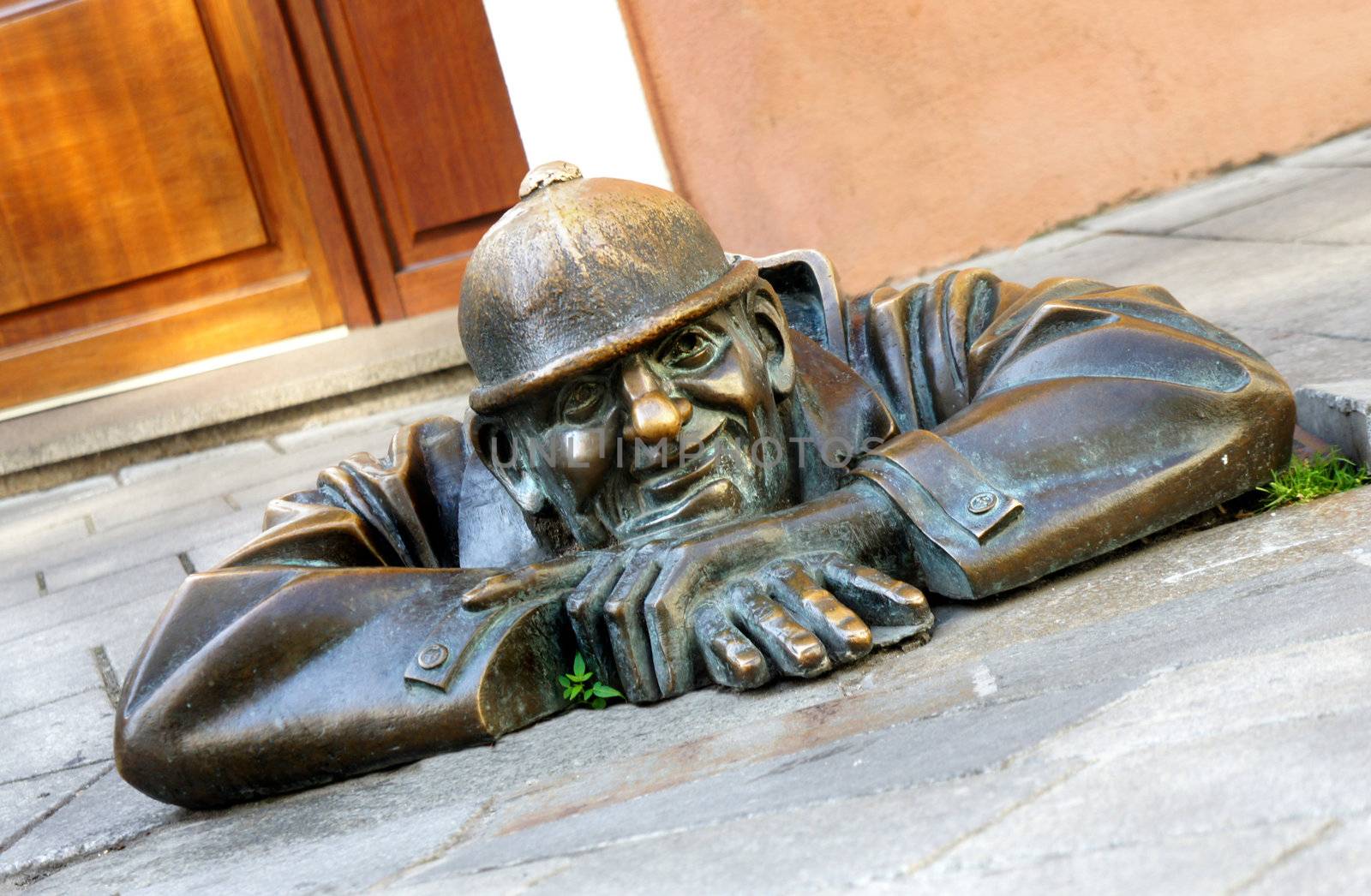 Bronze sculpture Man at work alias Cumil, Bratislava, Slovakia             