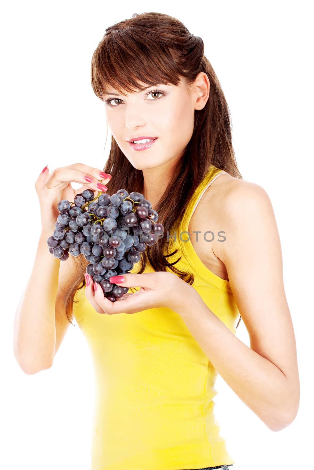 Pretty brunette yellow dressed holding a grape, isolated on white background