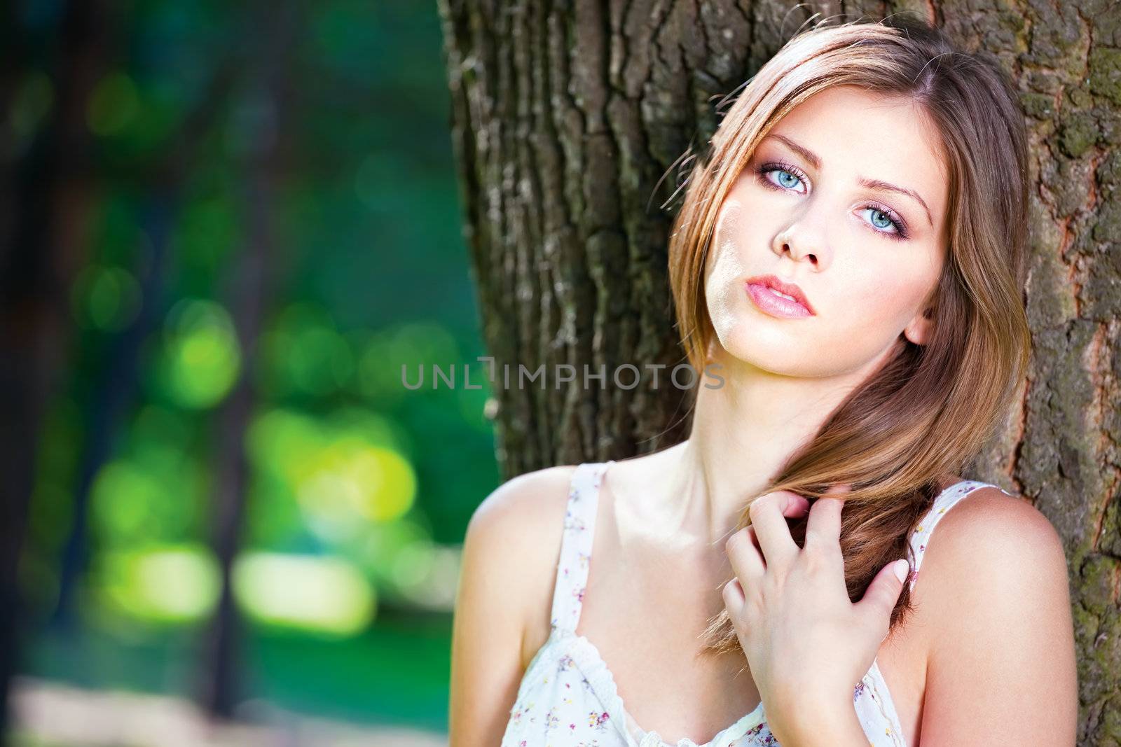 Cute brunette woman on sunny day in park, outdoor