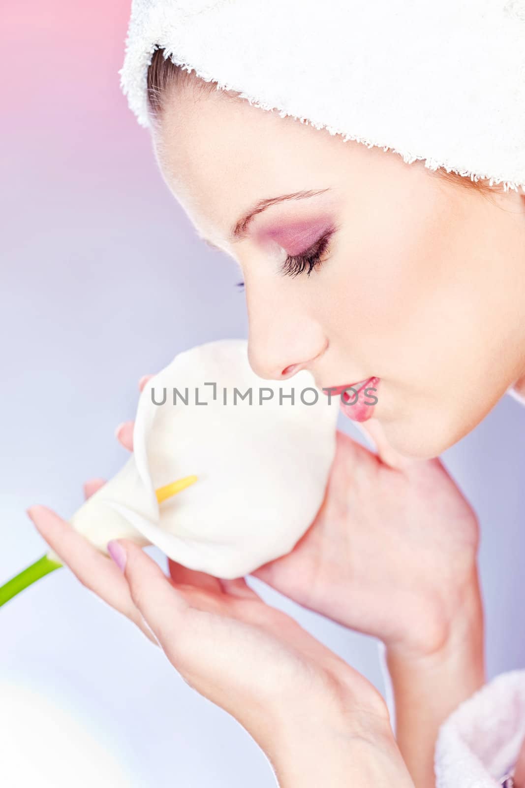 pretty woman with towel on head holding flower