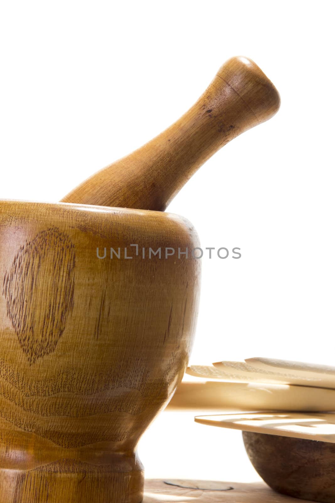 Wooden mortar and pestle on white background. Traditional kitchen equipment.